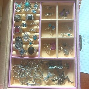Large jewelry box filled with rings earrings, and necklaces